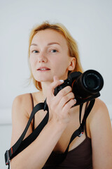 Beautiful woman photographer with digital camera. Photo shoot in minimalist style.