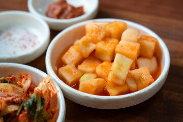 Spicy Korean Radish Kimchi in a Black Bowl