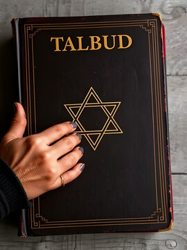Hands and Old Book Talmud. Hebrew Rabbinic Judaism, Jewish religious law. Torah, Hebrew Bible. Star of David on a dark cover. Holy Scripture containing the word of God.