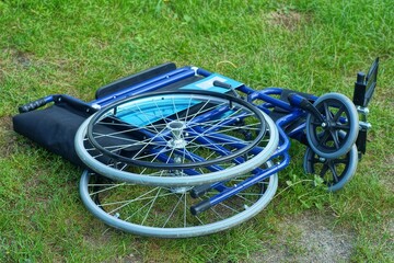 one blue folded new two-wheeled compact medical with black soft armrests iron rehabilitation empty...