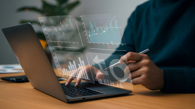 Person interacting with holographic data on a laptop screen