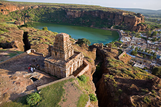 Aerial view of the fort and temple complex overlooking a tranquil lake, Badami, Karnataka, India.