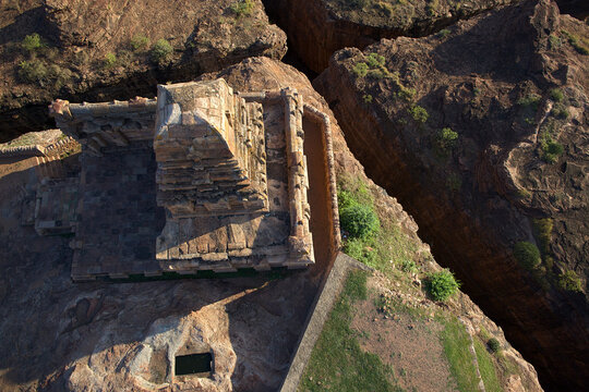 Aerial view of the ancient fortress amidst rugged rocks, its weathered stones glowing warmly under the sun's embrace, Sigiriya, Central Province, Sri Lanka.