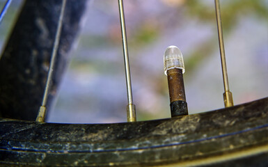 Close up of a bicycle tire valve stem protruding through the rim, ready for inflation or pressure...