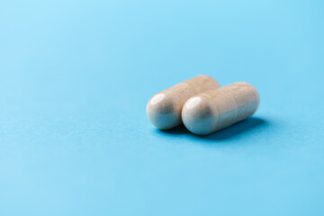Creatine tablets on paper background. Soft focus. Close up. Copy space.	