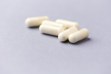 Creatine tablets on paper background. Soft focus. Close up. Copy space.	