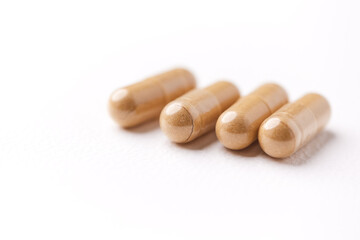 Creatine tablets on paper background. Soft focus. Close up. Copy space	