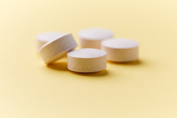 Creatine capsules on paper background. Soft focus. Close up. Copy space.	