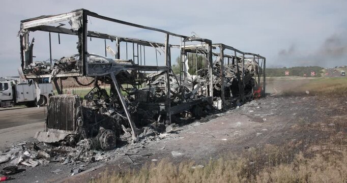 Smoldering Semi Truck On SIde of Freeway