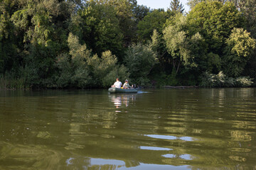 Father and son boating on a river and fishing