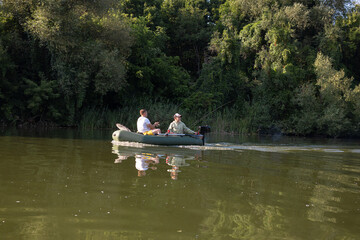 Father and son boating on a river and fishing