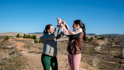 Two women staying motivated during outdoor run