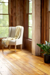 Fototapeta premium Light beige armchair with yellow throw blanket in rustic room furniture interior