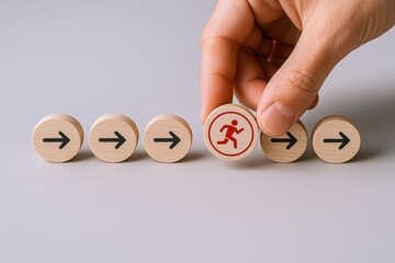 Hand Placing Wooden Disc with Running Icon Among Arrow Discs - Strategy and Innovation