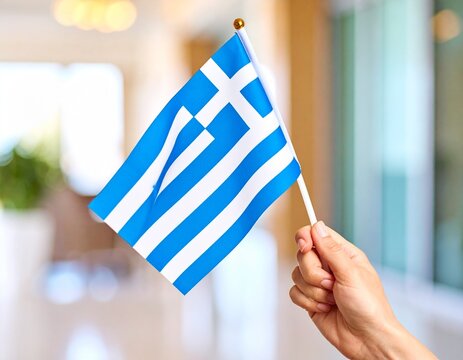 Hand Holding the National Flag of Greece