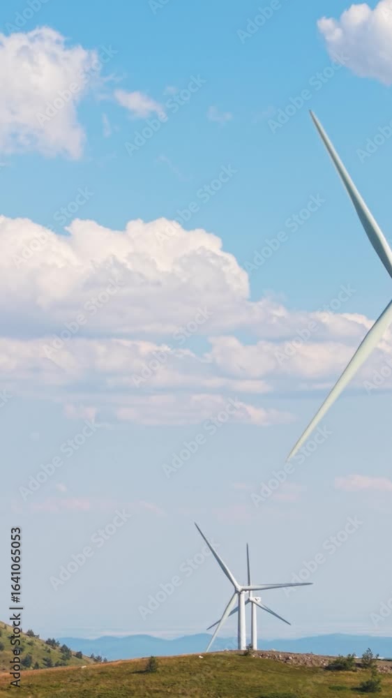 Poster stunning view of wind turbine head and blades moving rhythmically in the breeze with soft clouds dri