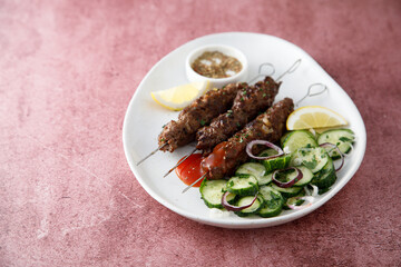 Traditional lamb kebab with cucumber salad