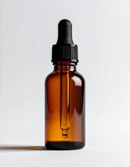 Studio Shot Of An Amber Bottle With A Black Dropper On White Backdrop