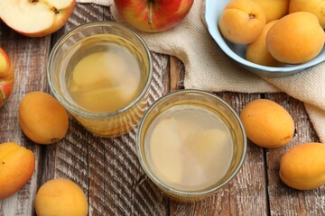 Tasty compot and fruits on wooden table, flat lay