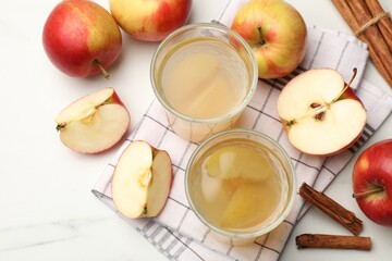 Tasty compot with apples and cinnamon on white table, flat lay