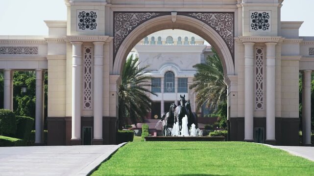 Entrance exterior view of entrance of the famous Zabeel Palace or Sheikh Mohammed Palace in Dubai United Arab Emirates featuring a grand arch, fountain, and horse statue