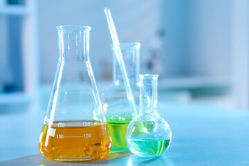 Solution chemistry. Laboratory glassware with different samples on table indoors, closeup. Space for text