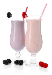 Different tasty milkshakes in glasses and ingredients isolated on white