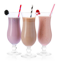 Different tasty milkshakes in glasses isolated on white