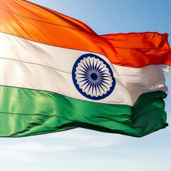 Indian flag waving against a blue sky