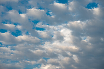 Blue sky with scattered white cumulus clouds. 
