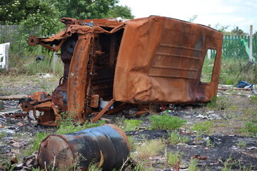 Rusty Abandoned Vehicle Wreck in a Grass Overgrown Junkyard