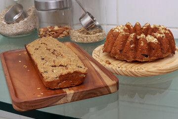 Homemade oatmeal bread with nuts and raisins displayed on a wooden board 