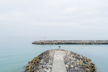 The quiet and peaceful atmosphere of a harbor jetty on a foggy morning tranquility concept