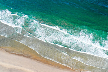 A dynamic and powerful seascape with lines of waves rolling to the shore ocean energy concept