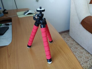 Red color tripod on the table