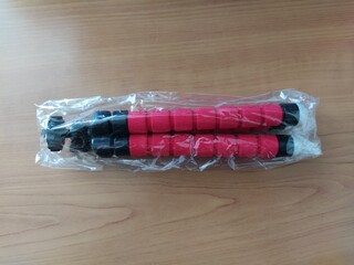 Red color tripod in package on a table