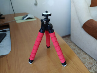 Red color tripod on the table