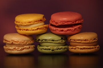 Colorful Macarons Stacked Against a Warm Background in Closeup View