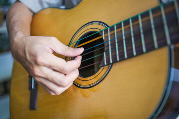 Close Up Of Musician's Fingers strumming The Strings Of Guitar