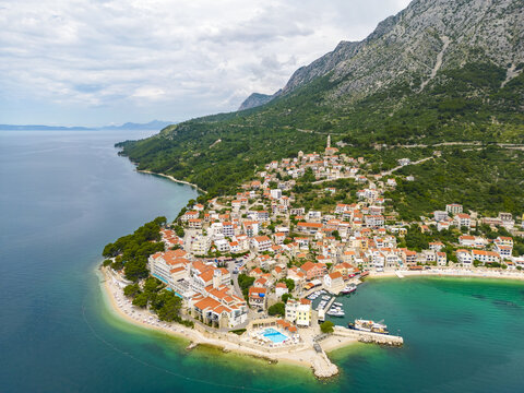 Aerial view of the quaint coastal village nestled between the turquoise sea and the rugged mountain, Igrane, Split-Dalmatia County, Croatia.
