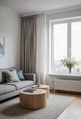 A cozy corner of a modern living room, featuring a comfortable gray sofa with blue accent pillows and a simple vase of flowers for a touch of serene elegance.
