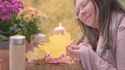 woman's thoughtful gaze among colorful array flowers, candles glowing in garden, and fallen leaves, allergic reaction fear, autumn garden, floral calm spirit, celebrating vibrant season's beauty