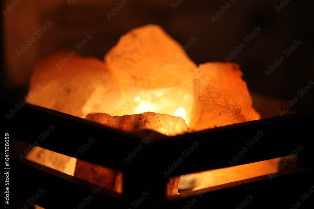 Poster a lit candle in a box with a warm glow, suitable for use as a decorative element or symbol