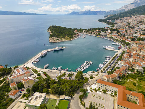 Aerial view of the harbor filled with boats and yachts contrasting with the terracotta roofs of the town, Makarska, Splitsko-dalmatinska &Aring;&frac34;upanija, Croatia.