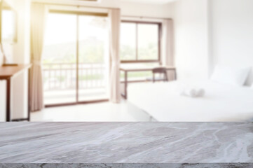 Marble tabletop with blurred bright bedroom interior 