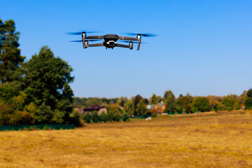 Close-up view of drone flying over agricultural field. Flying drone quadcopter over the harvest...