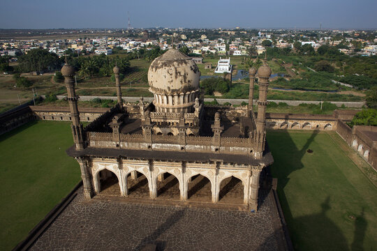 Aerial view of the Ibrahim Rouza complex, with its intricate carvings and stately dome, rises from the verdant landscape, Ibrahim Roza Road, Vijayapura, Karnataka, India.