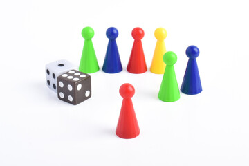 Colorful board game figures and dice isolated on white background