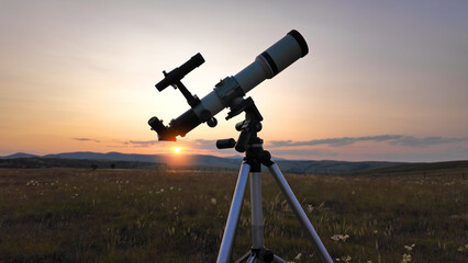 Preparing for night sky observing with a astronomical telescope just before sunset in the...