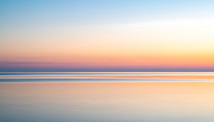 Fototapeta premium Serene Sunset Over Calm Ocean Displaying Soft Pastel Colors.
